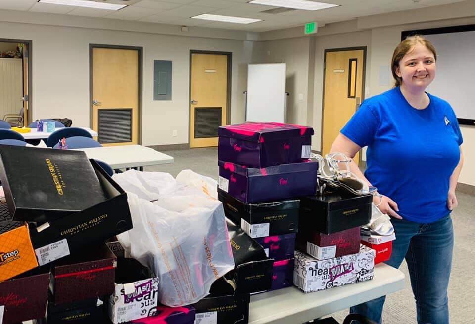 Stepping Up Manager Coral with the fifty six pairs of shoe donation for the Utah Foster Care Foundation
